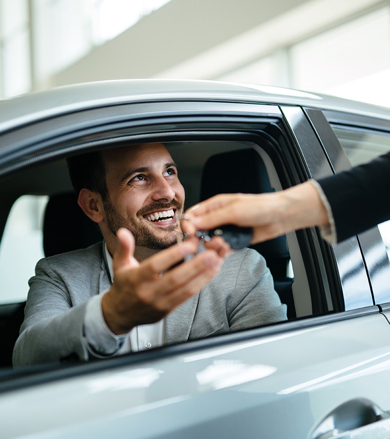 portrait-of-happy-customer-buying-new-car-RYEWB4F.jpg